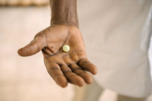 A close-up of Acoziborole Winthrop pills in a blister pack, representing the single-dose oral treatment for sleeping sickness.