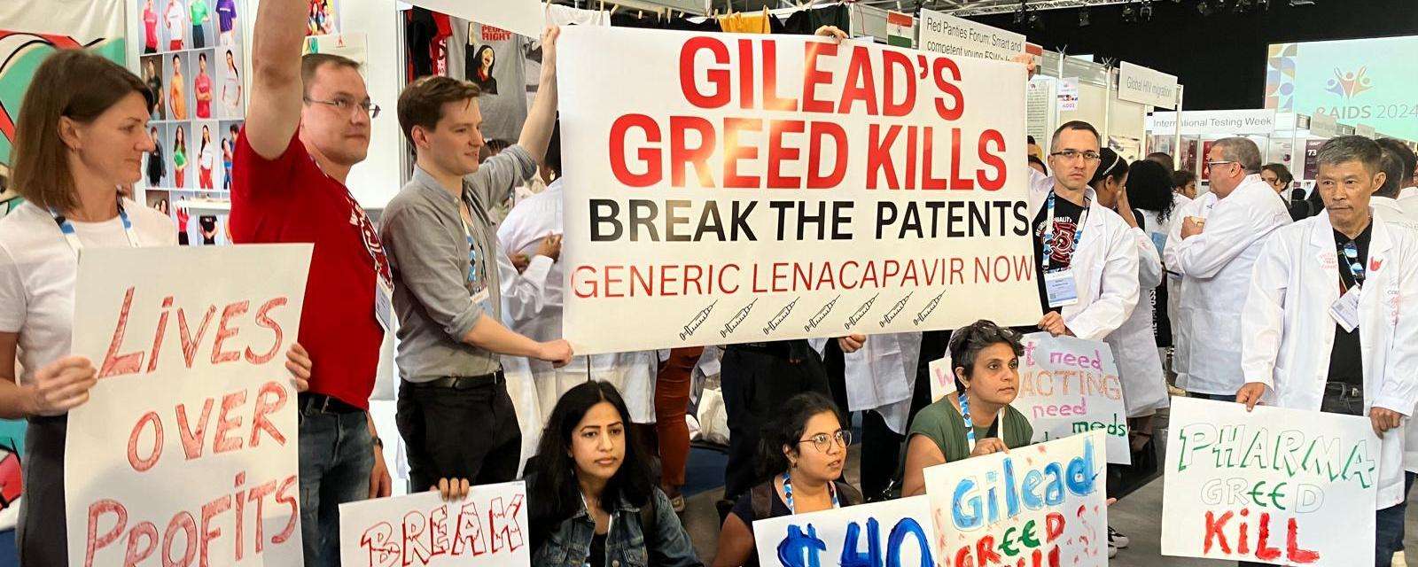 MSF staff members and activists holding protest signs targeting Gilead during an International AIDS Society conference over access to HIV prevention drug lenacapavir.