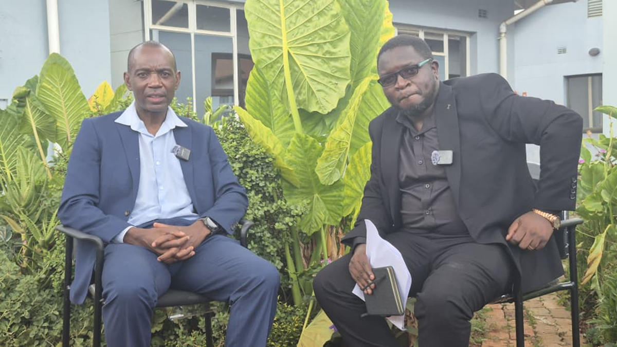 Journalist Michael Gwarisa seated with Dr Mugove Madziyire during an interview discussing infertility, stigma, and male fertility health in Zimbabwe.