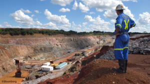 A miner standing at a copper mine in Zambia as the country faces pressure from the United States over a minerals for health aid deal