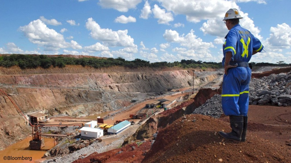 A miner standing at a copper mine in Zambia as the country faces pressure from the United States over a minerals for health aid deal