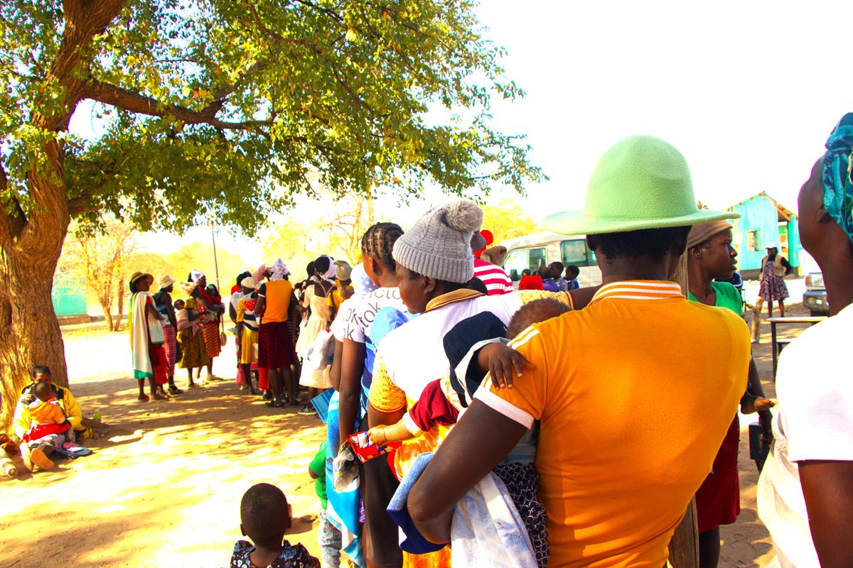 Women in Gokwe, Zimbabwe queue for child malnutrition screening services for their children at a health facility.