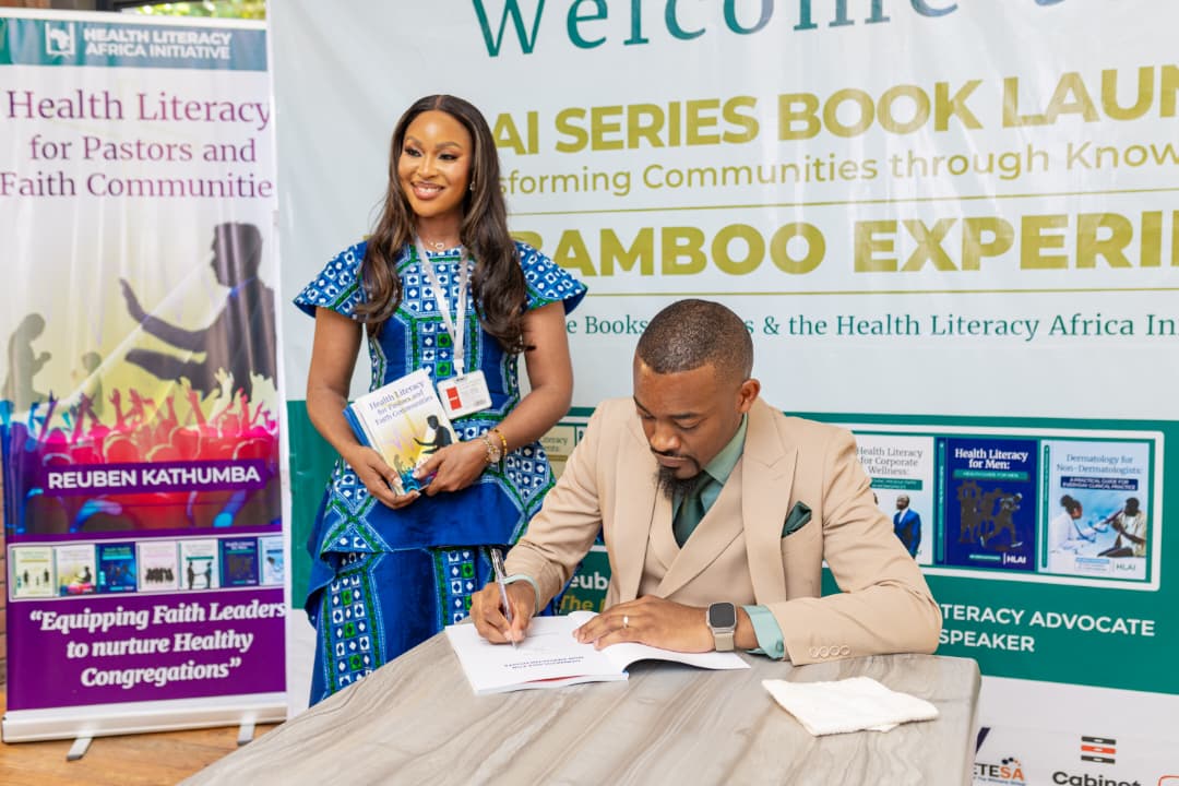 Zimbabwean pharmacist Reuben Katumba signs a copy of his health literacy book for a delegate during the launch of his seven-book series in Zimbabwe.