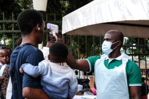 Health official screening people for Ebola symptoms outside Kibuli Muslim Hospital in Kampala Uganda during Bundibugyo Ebola outbreak