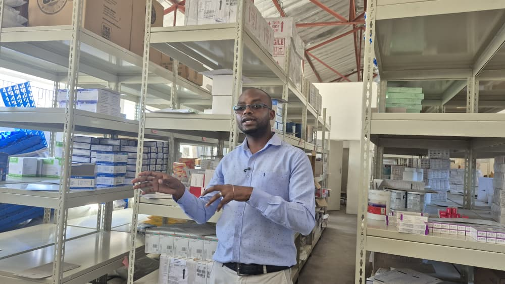 Pharmacy technician Tinashe Bako showing stocked medicines at Mahusekwa Hospital in Zimbabwe