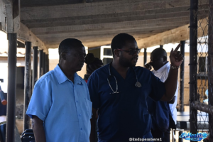 Dr Takudzwa Sasa, Assistant Medical Director at Karanda Hospital, standing with Reverend Mark Sukulao, hospital chaplain, at Karanda Mission Hospital in Zimbabwe, representing healthcare and spiritual support collaboration.