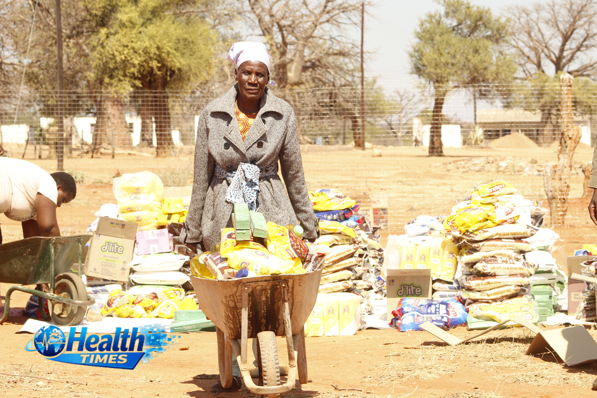 Gogo Lucia Changunda pushes a wheelbarrow carrying food and dignity items after receiving flood relief assistance from the Zimbabwe Red Cross Society in Beitbridge.