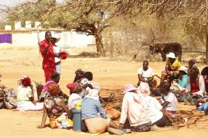 Komboni, a Zimbabwe Red Cross Society official, briefs villagers and recipients of humanitarian assistance before a flood relief distribution in Beitbridge.