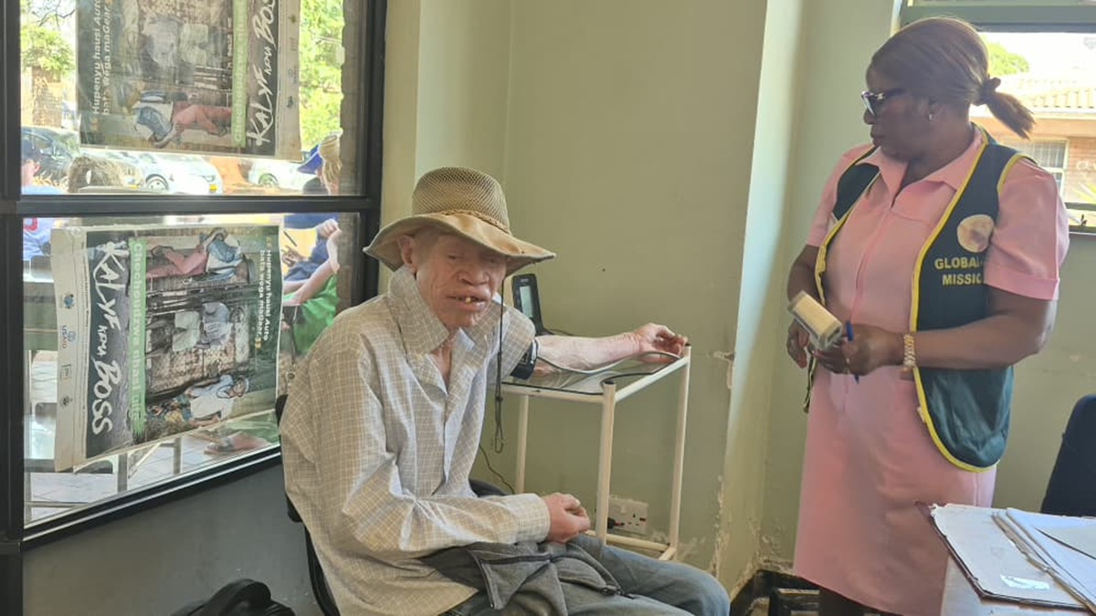 Josam Kuvandi, a person with albinism, speaks about access to skin cancer treatment during a Global Aid Missions outreach in Zimbabwe