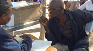 Older man receiving care from a nurse for a non-communicable disease in Gokwe, Zimbabwe